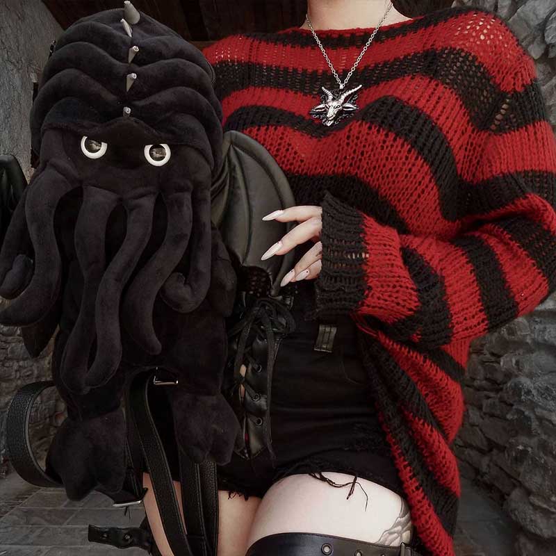 Girl in black and red striped sweater, with Cthulhu plush toy backpack