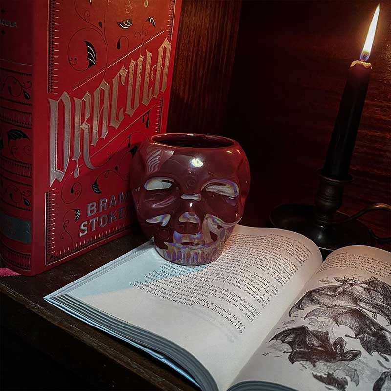 Dracula book and red skull mug