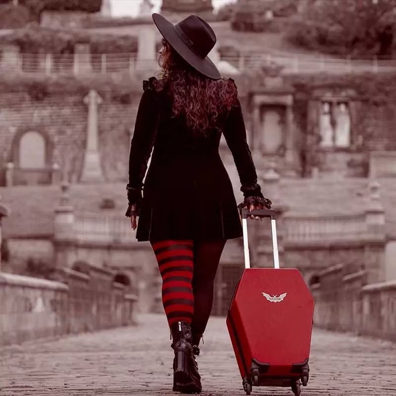 Gothic girl with red coffin luggage