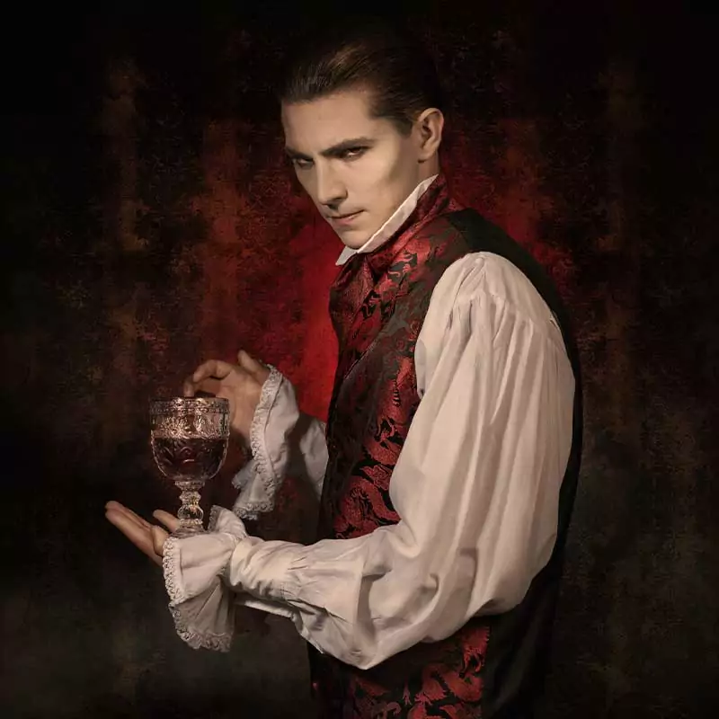 Classy Goth man with a glass of wine